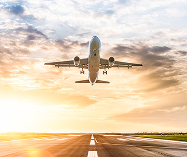 passenger airplane taking of at sunrise